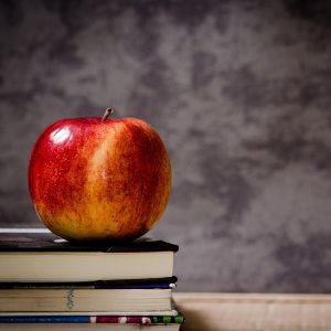 An apple on a stack of books